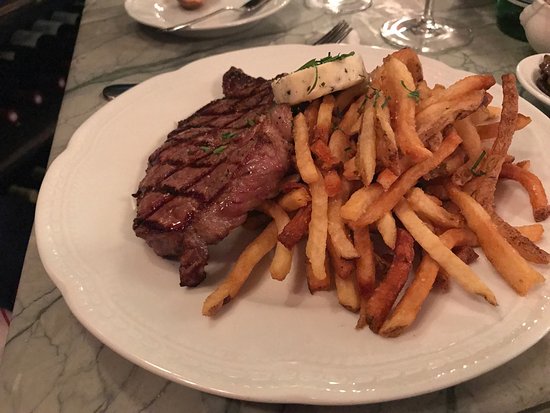 Petit Louis Bistro signature dishes Steak Frites, French Onion Soup, Escargots de Bourgogne, Trout Amandine, Duck Confit, Short Rib.